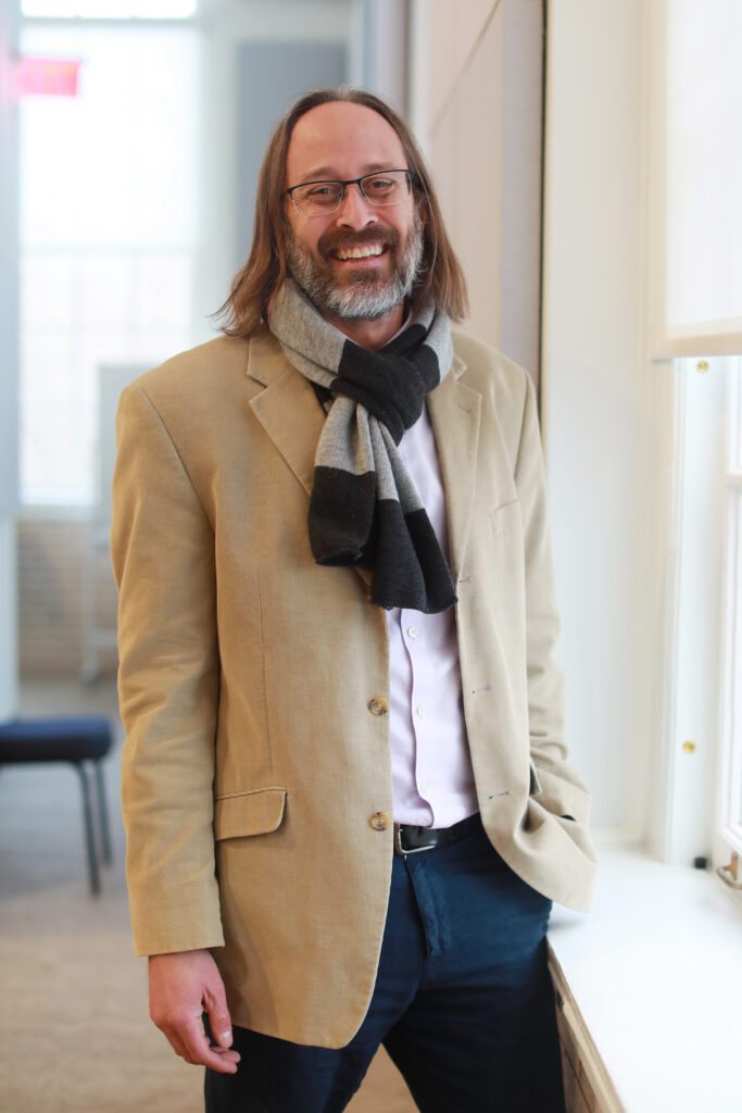 Michael Reno standing near a window