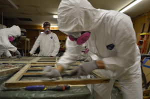 students working on window restoration.