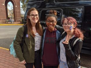 three students wearing "I voted" stickers