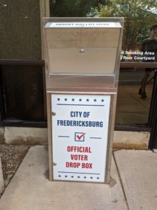 This is an image of a voter drop box. it says on it "City of Fredericksburg Official Voter Drop Box."