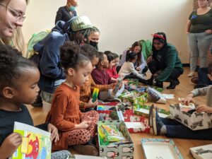 Children opening wrapped gift boxes