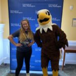 Student posing with Sammy D Eagle