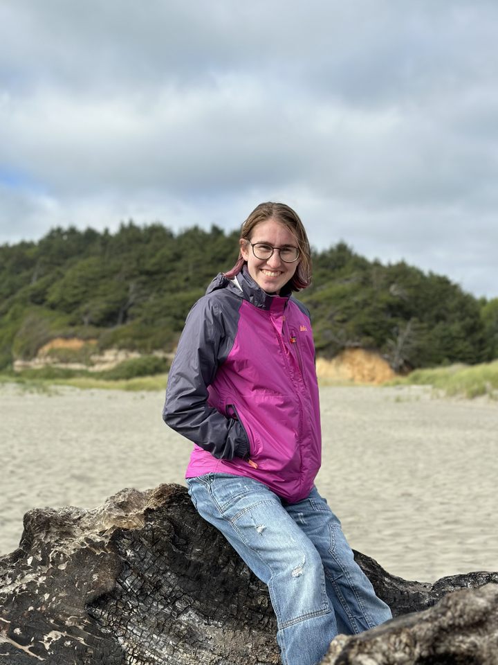 Laurie posing for a photo on a rock.