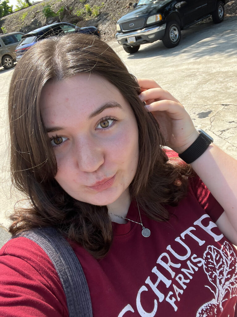 Summers, with short brown hair and a red shirt.