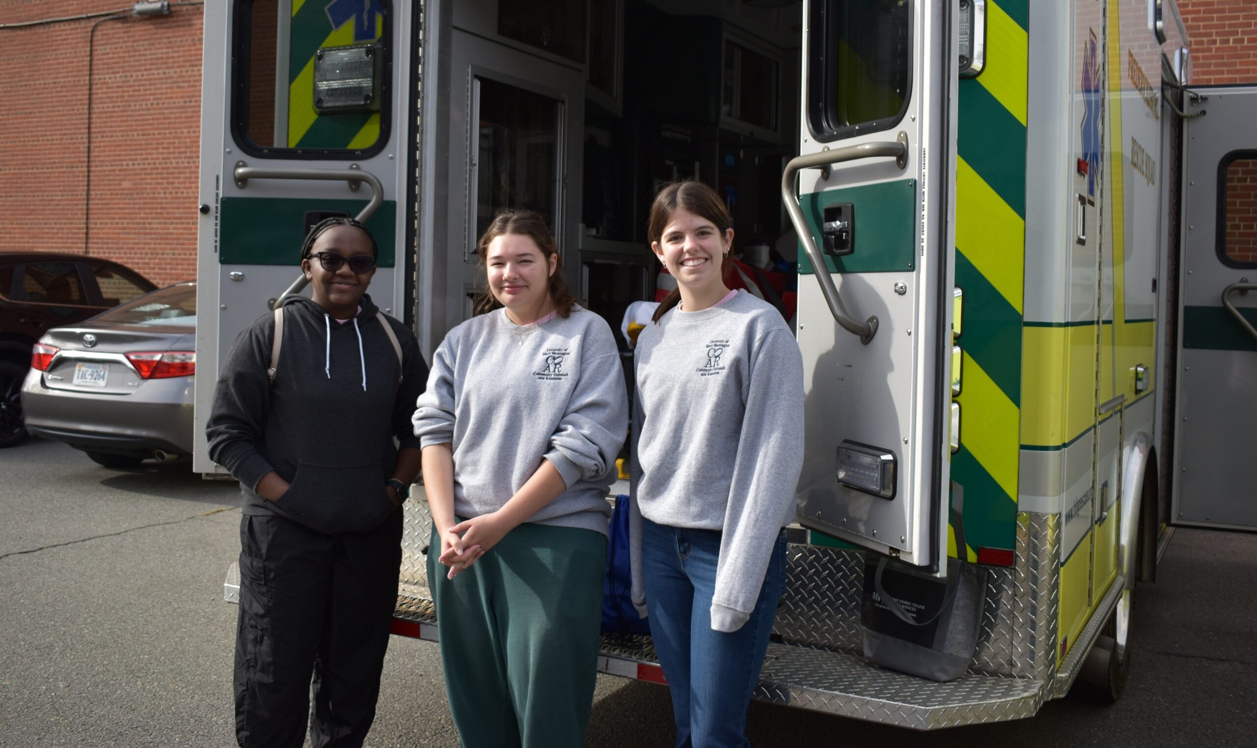 Student standing in front of ambulance. 