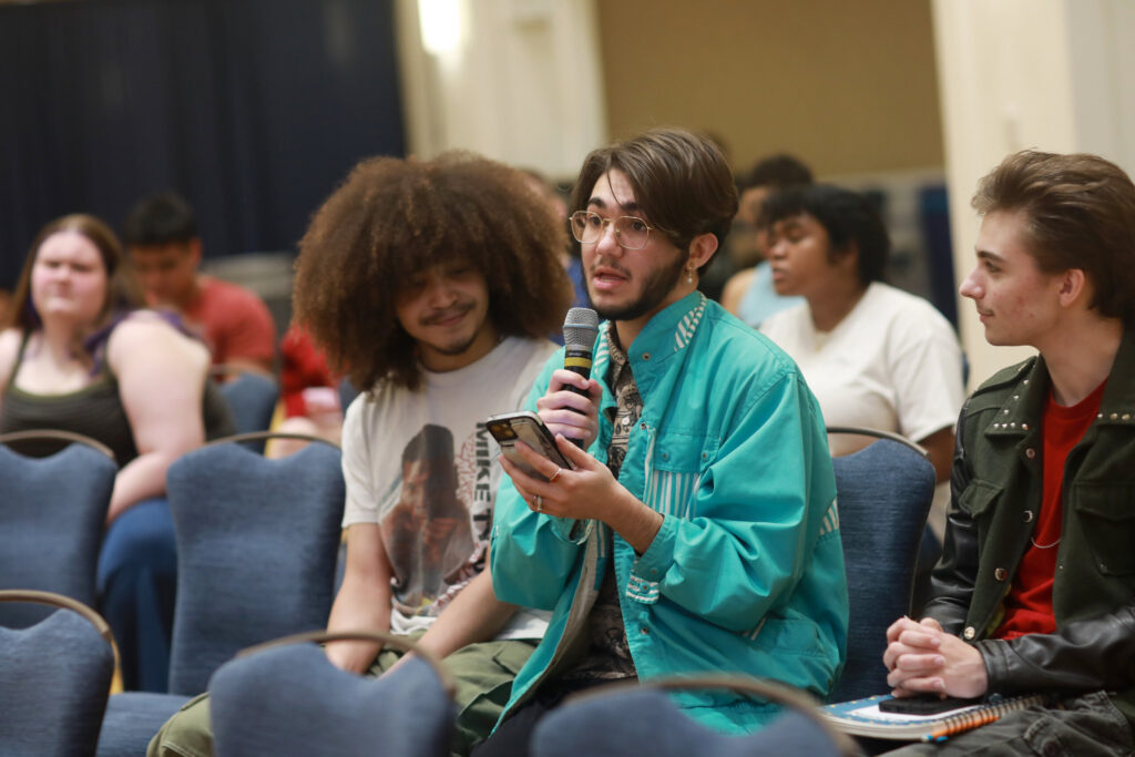 Student speaking into a microphone