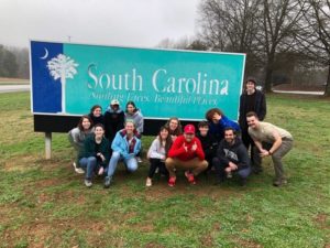 picture of students in front of NC sign.
