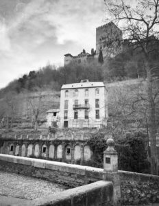 Black and white photo of a ghostly old structure.