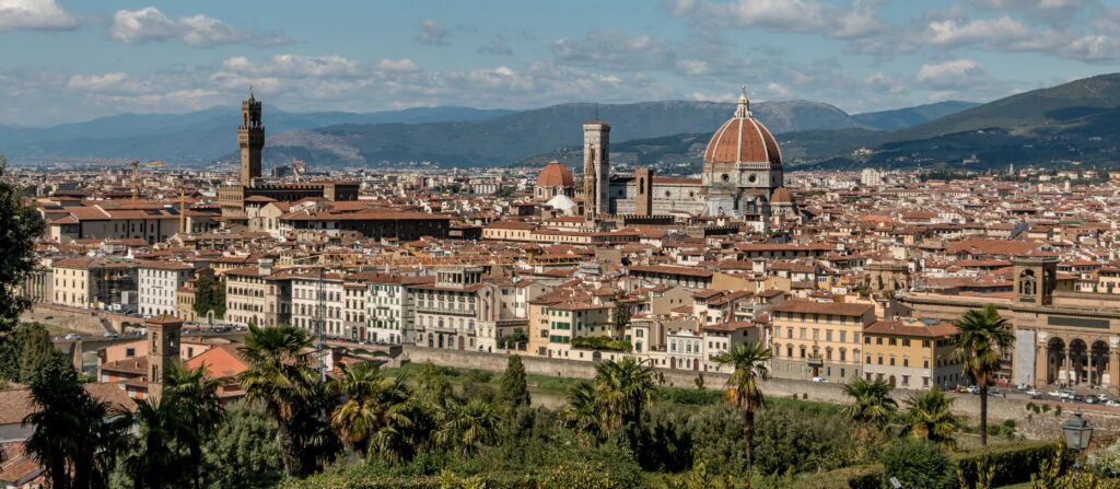 Florence - white and brown concrete building near green trees under blue sky during daytime.